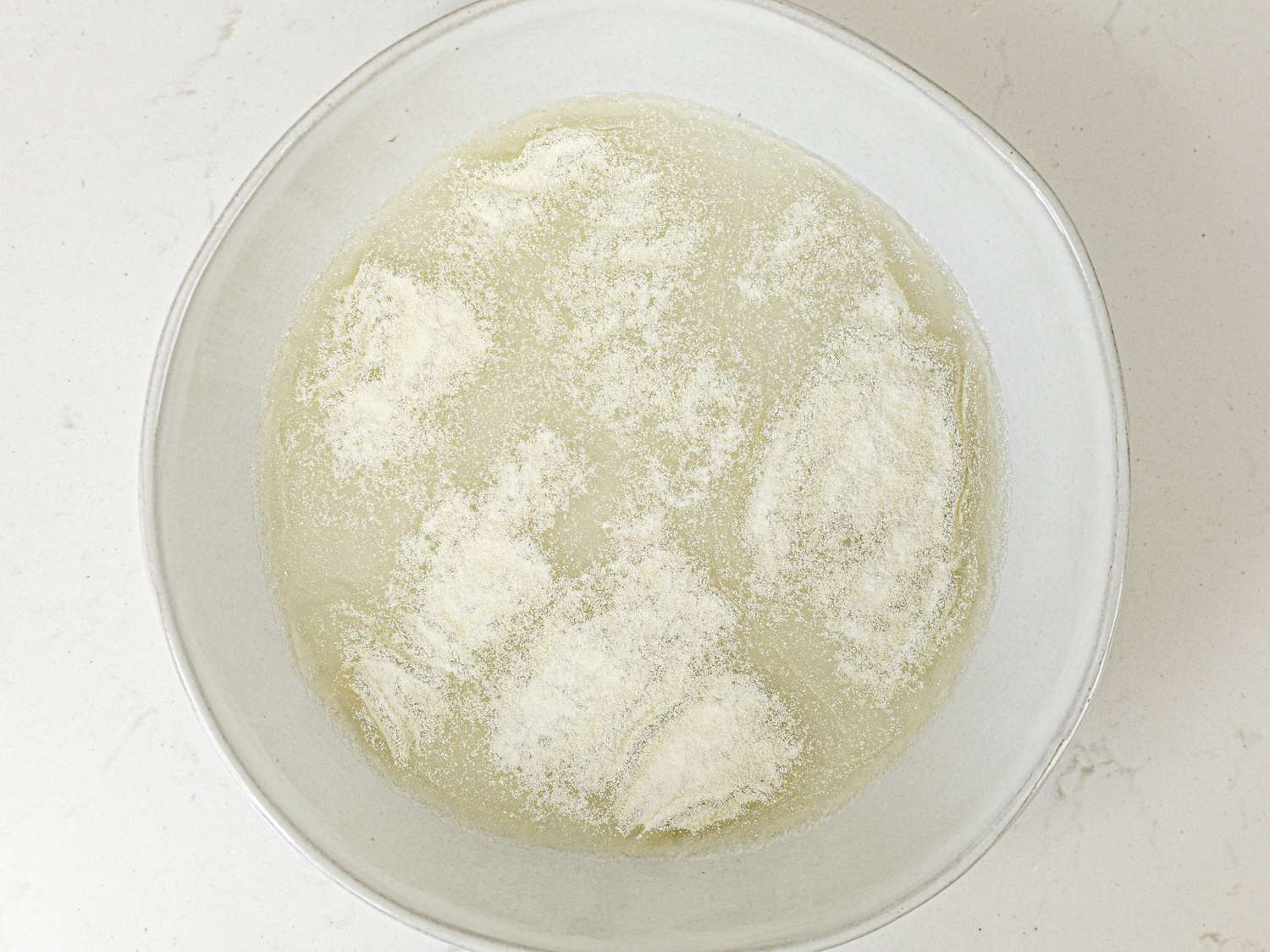 Overhead view of a bowl with partially mixed gelatin