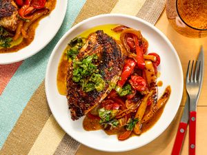 Grilled chicken with sauted vegetables and garnish on a plate