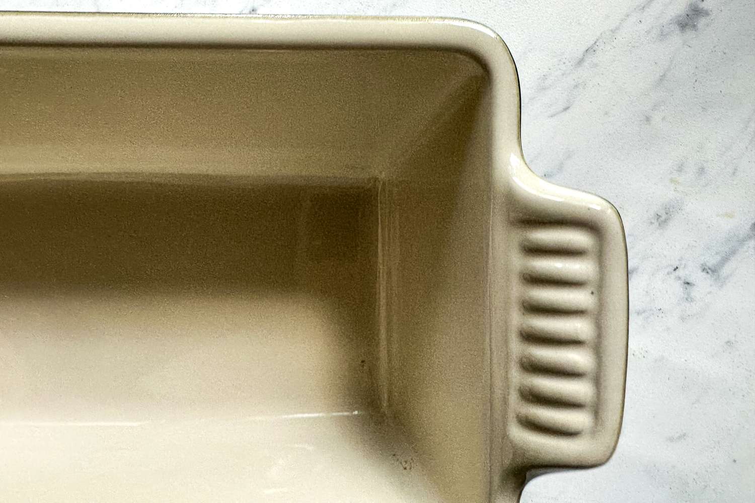 A close-up of the handle on the Le Creuset Heritage Loaf Pan