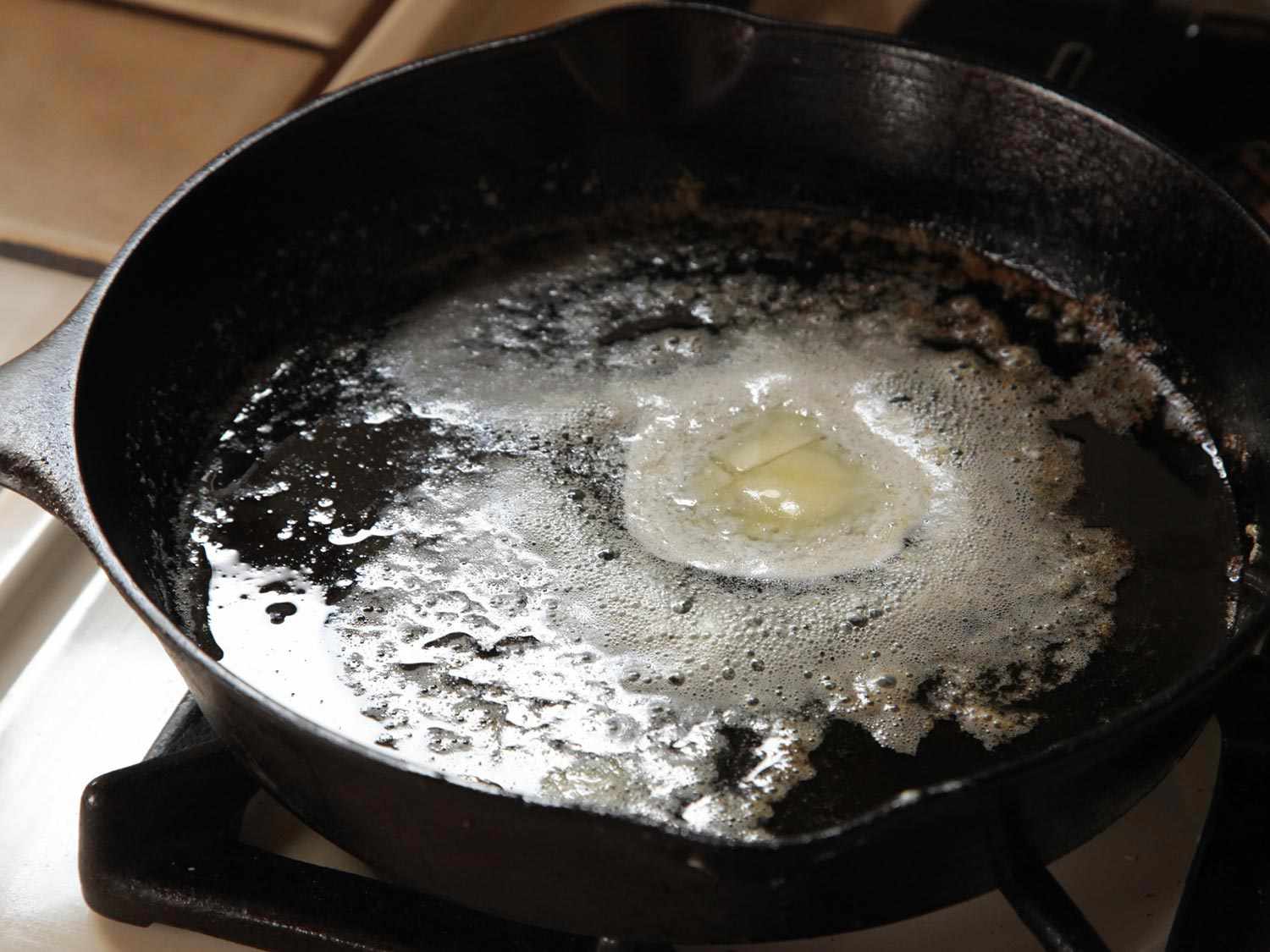 Melting butter and oil in a cast iron pan for pepperoni garlic knots
