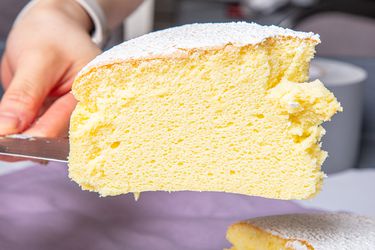 Close-up of a slice of Japanese cheesecake being served on a spatula