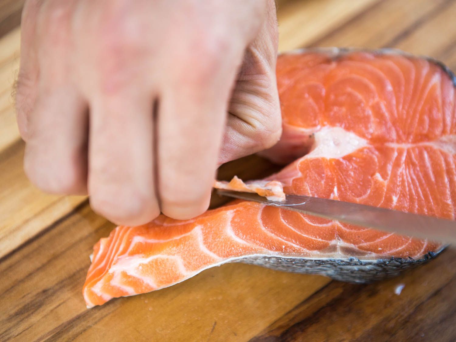 Trimming salmon steaks.