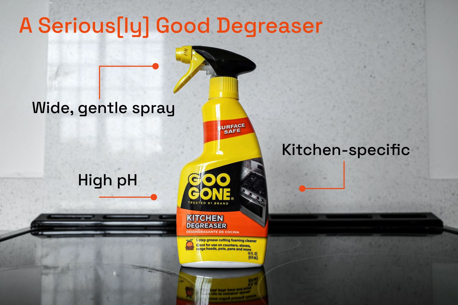 A bottle of Goo Gone degreaser on a glass stovetop