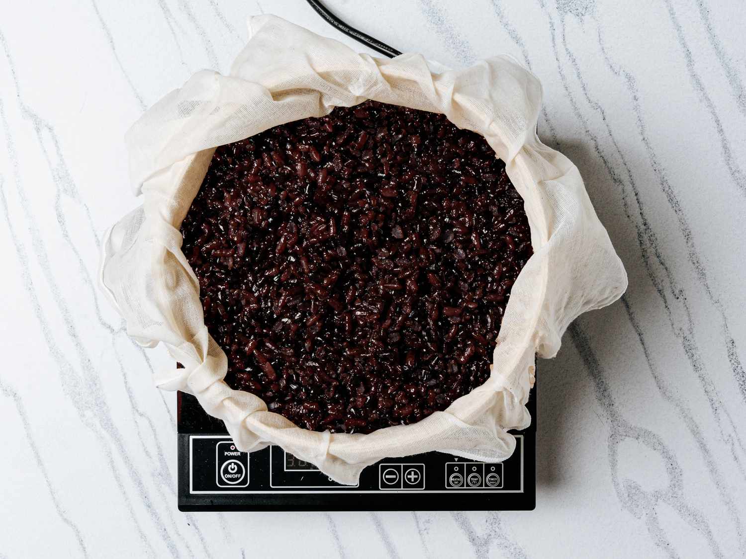 Rice steamed in bamboo steamer lined with cheesecloth 