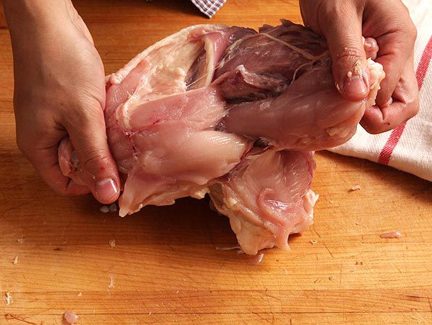 Breast meat half hanging off front of the bird