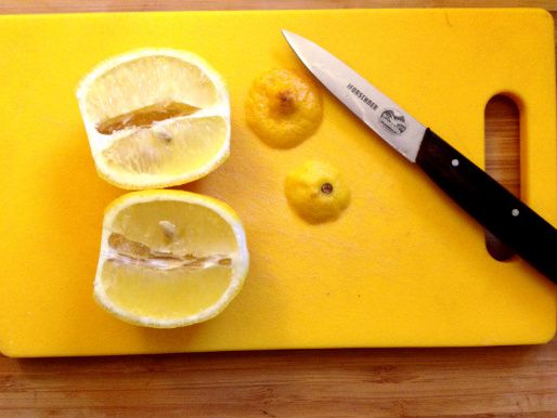 A lemon that has been topped, tailed, and cut in half.