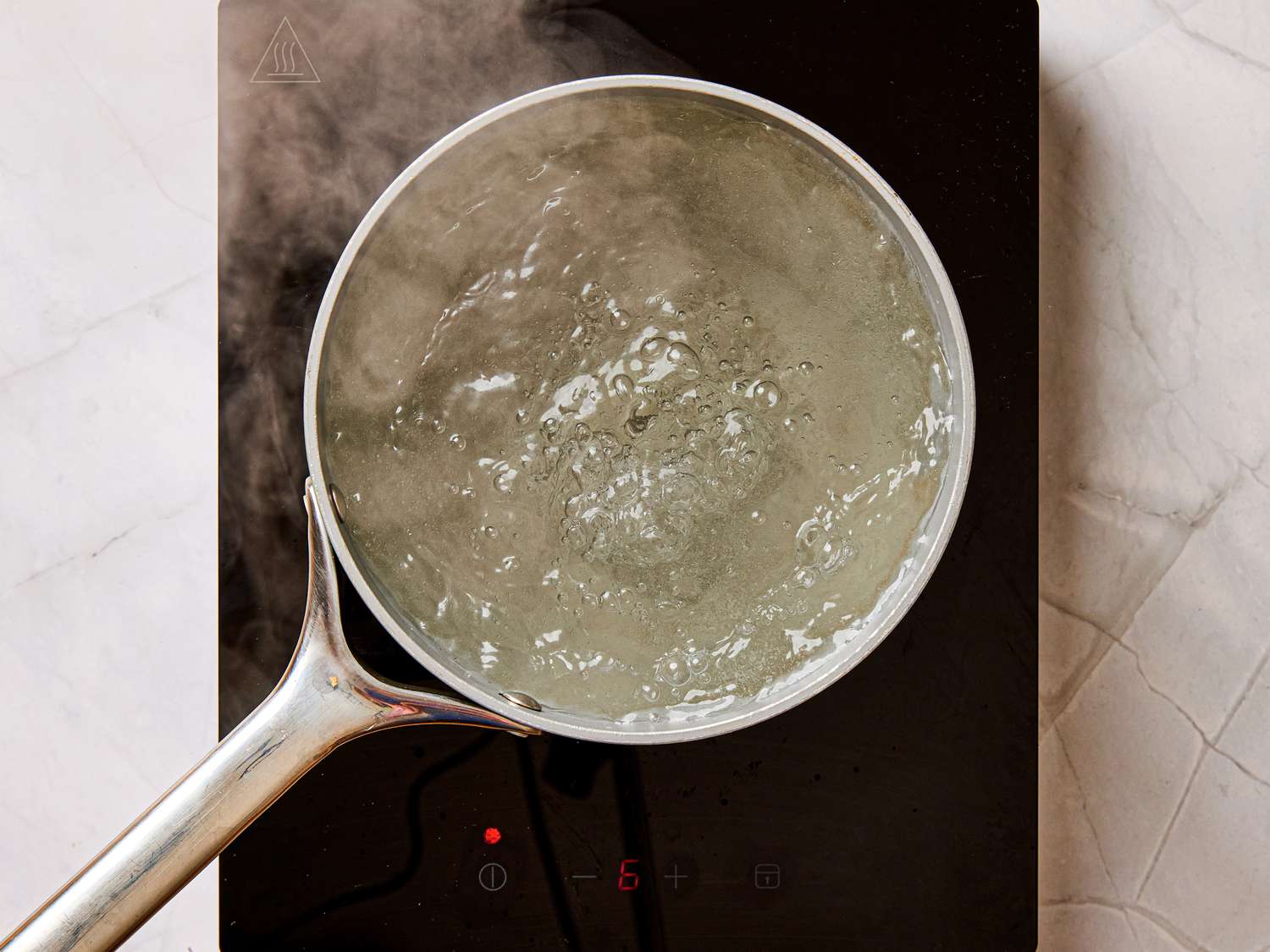 Pot of water boiling on an electric stovetop