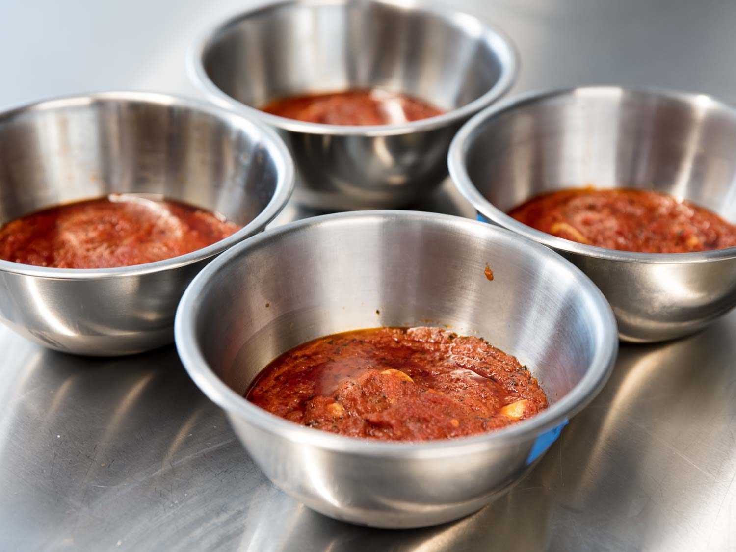 Bowls of tomato sauce made with both garlic with and without the germ removed.
