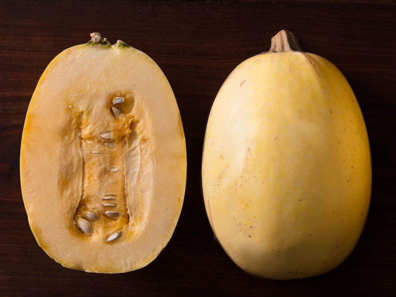 Spaghetti squash halved and displayed cut side down and cut side up