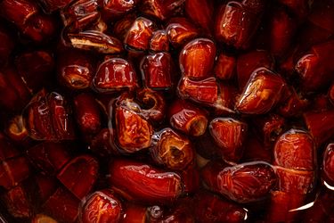 Closeup of sliced dates soaking in liquid