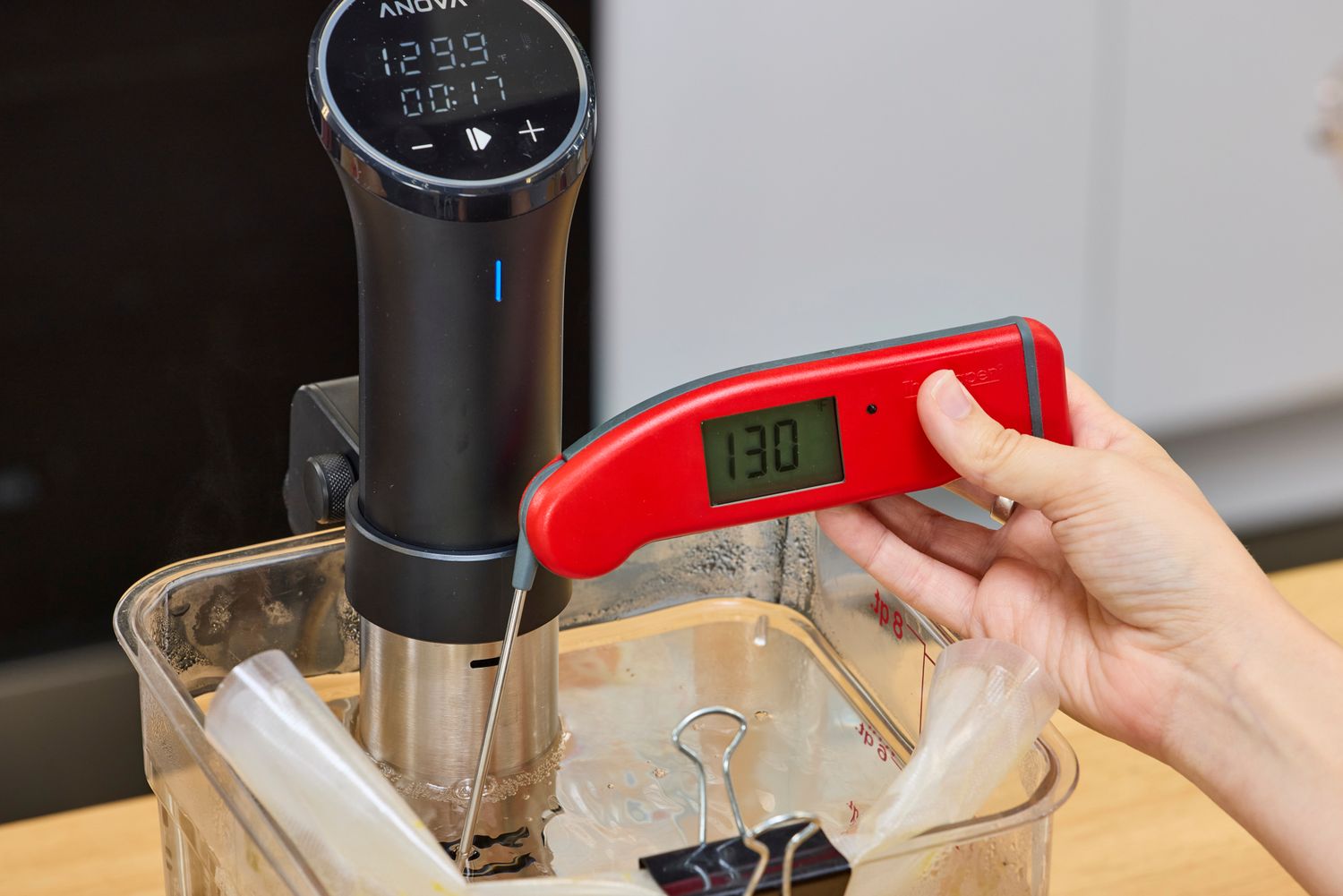 Anova Culinary Precision Cooker 3.0 in use with a thermometer showing 130 degrees