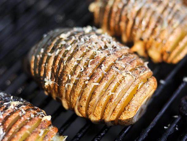 Closeup ofthe potatoes cooking on a grill grate.