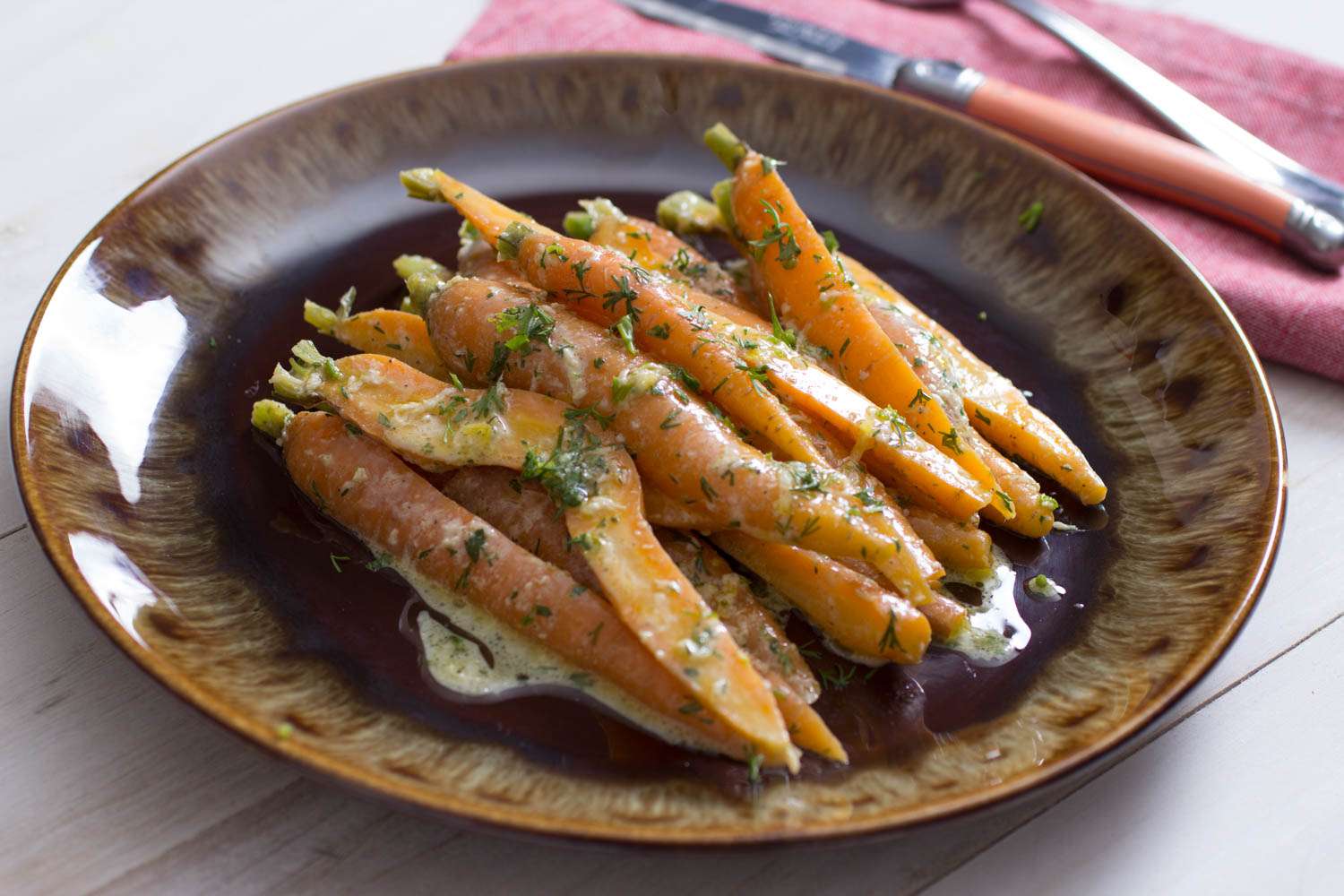 A plate of carrot salad with tahini dressing.