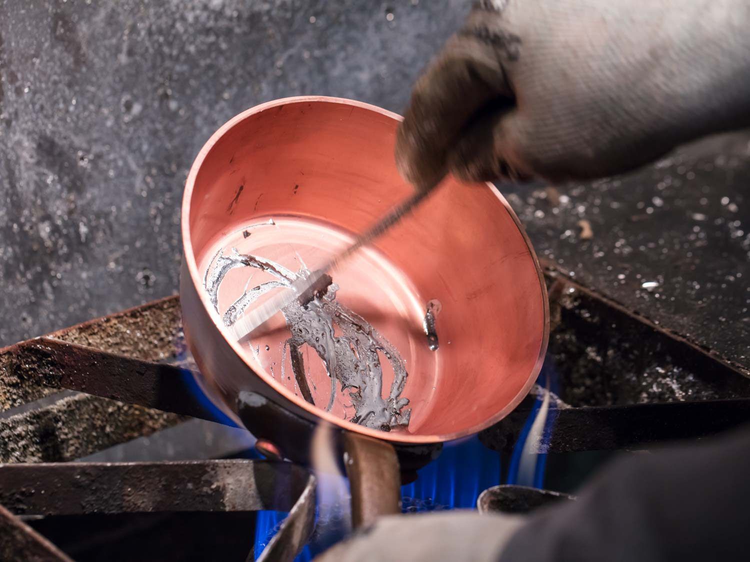Lining a copper saucepan with tin.