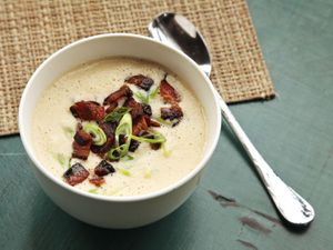 A bowl of easy-to-make creamy cauliflower soup garnished with bacon