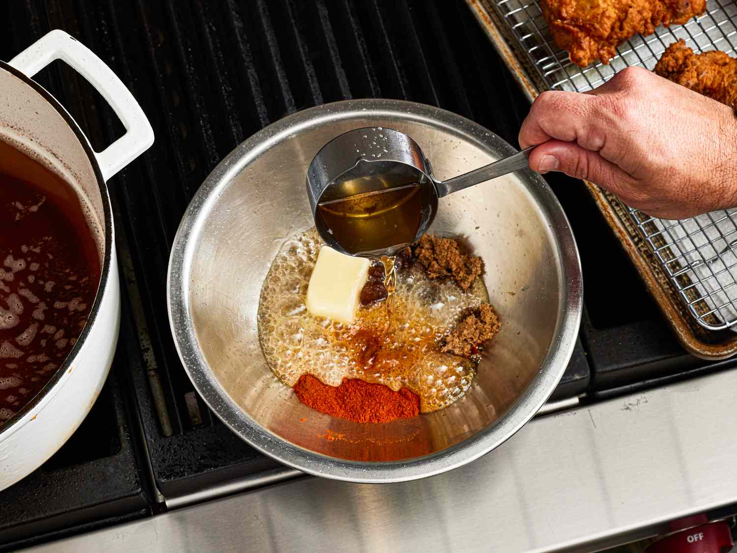 Overhead view of pouring oil into spice mixture