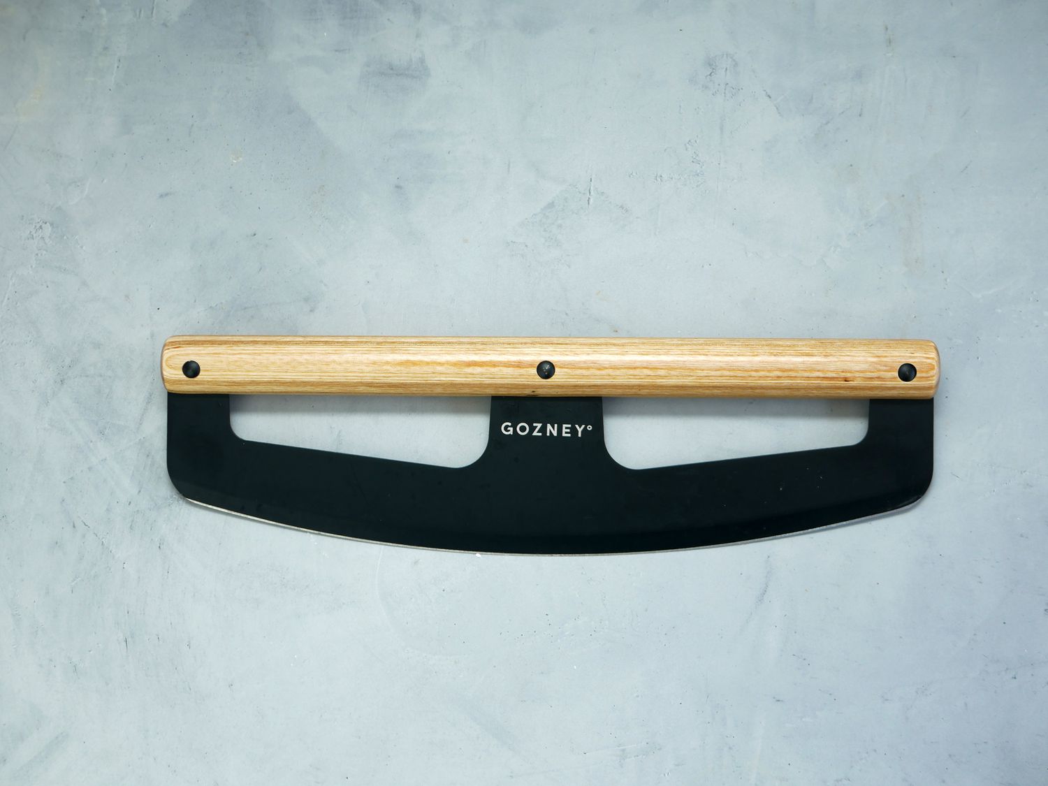 gozney pizza cutter on a gray surface