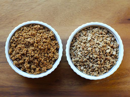 Overhead view of two ramekins of grape nuts. The commercial grape nuts on the left are a darker shade than the DIY batch on the right.