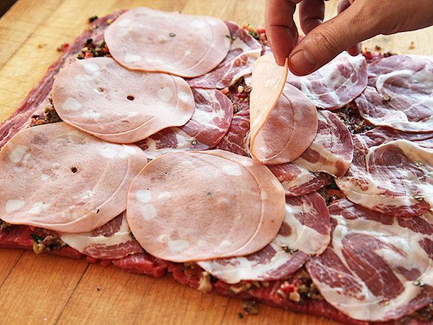 Layering cold cuts onto piece of butterflied flank steak