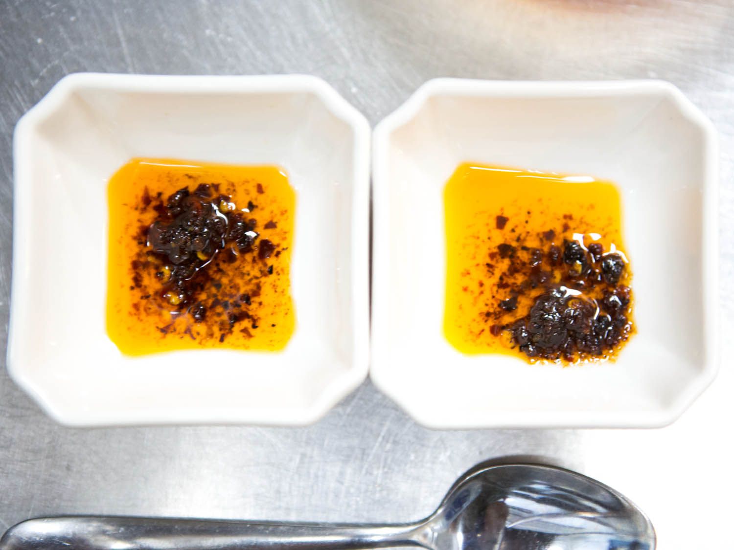 Two small dishes of chile oil. 