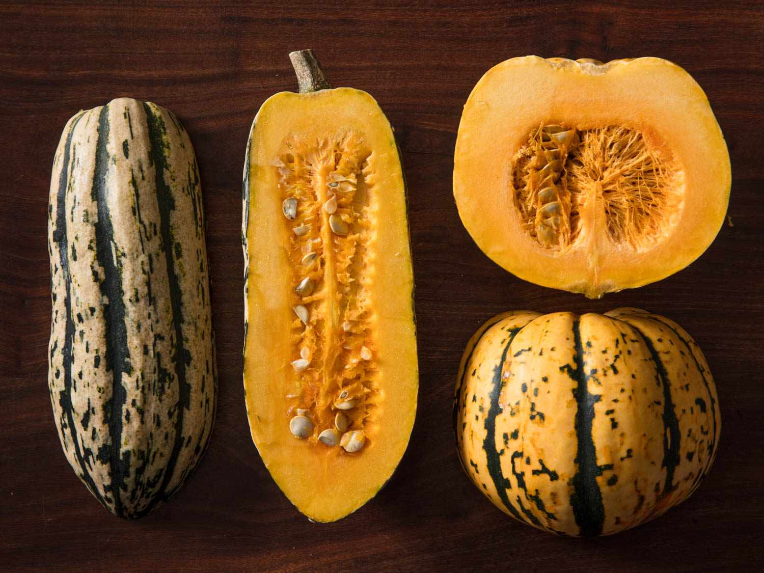 Delicata squash and sweet dumpling squash halved and displayed cut side down and cut side up