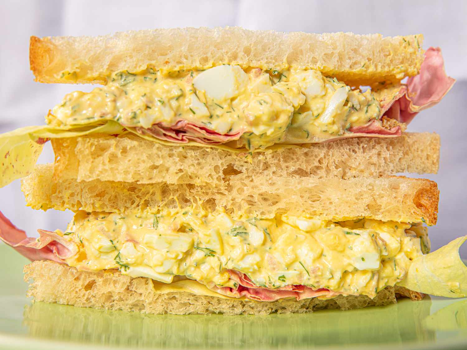 Egg salad sandwich with layers of bread and salad filling
