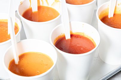 Cups of tomato soup with spoons presented for a taste test