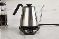 The OXO gooseneck kettle on a marble countertop.