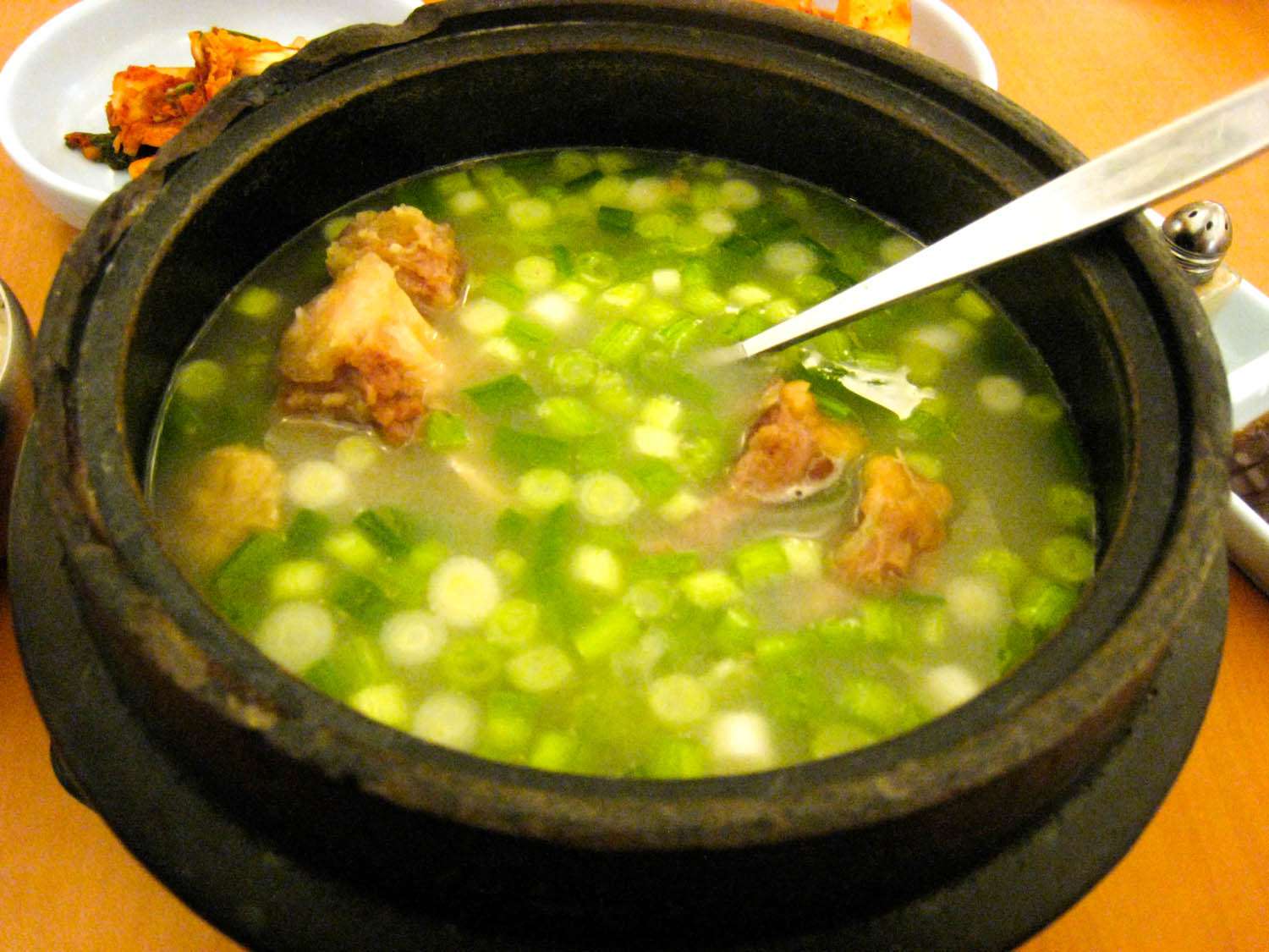 a claypot of ggorigomtang with serving spoon