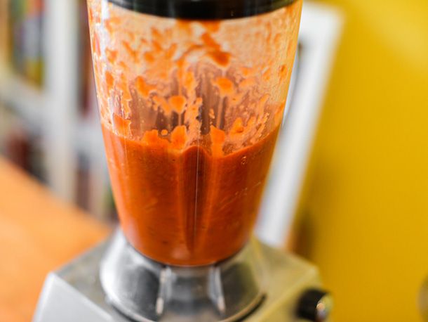 The tomato-chipotle sauce is puréed in a blender.