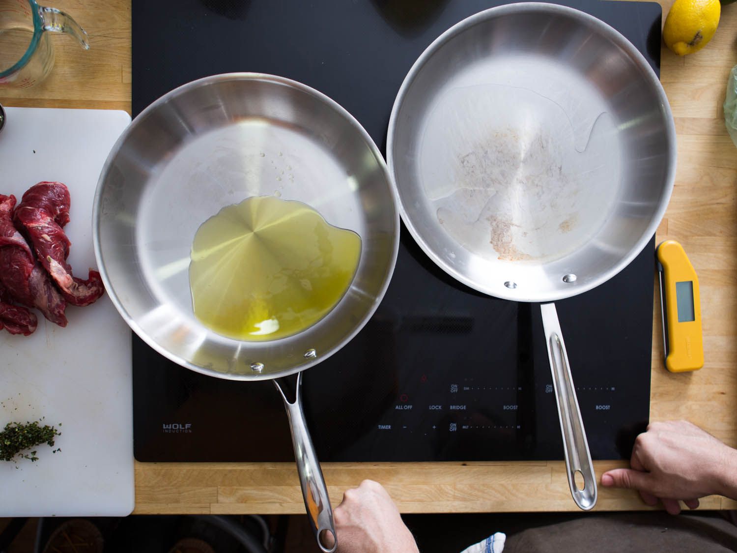 An over head shot of two side-by-side stainless steel skillets. The left skillet has oil in it.