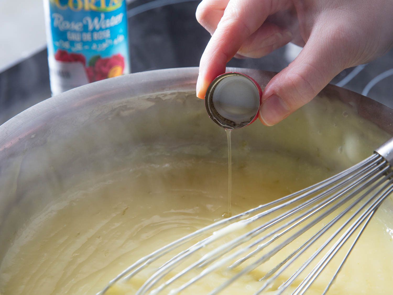 Rosewater is whisked into the custard off the heat.