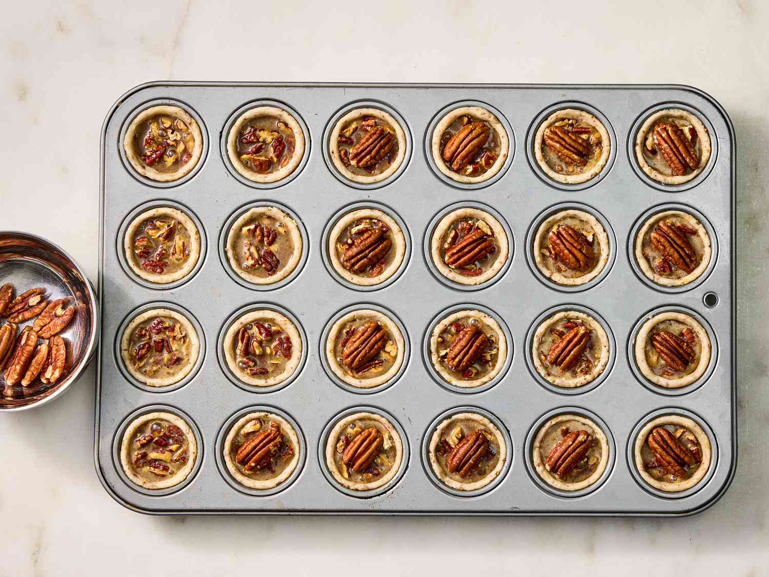 filled muffin tins with pecan mix 