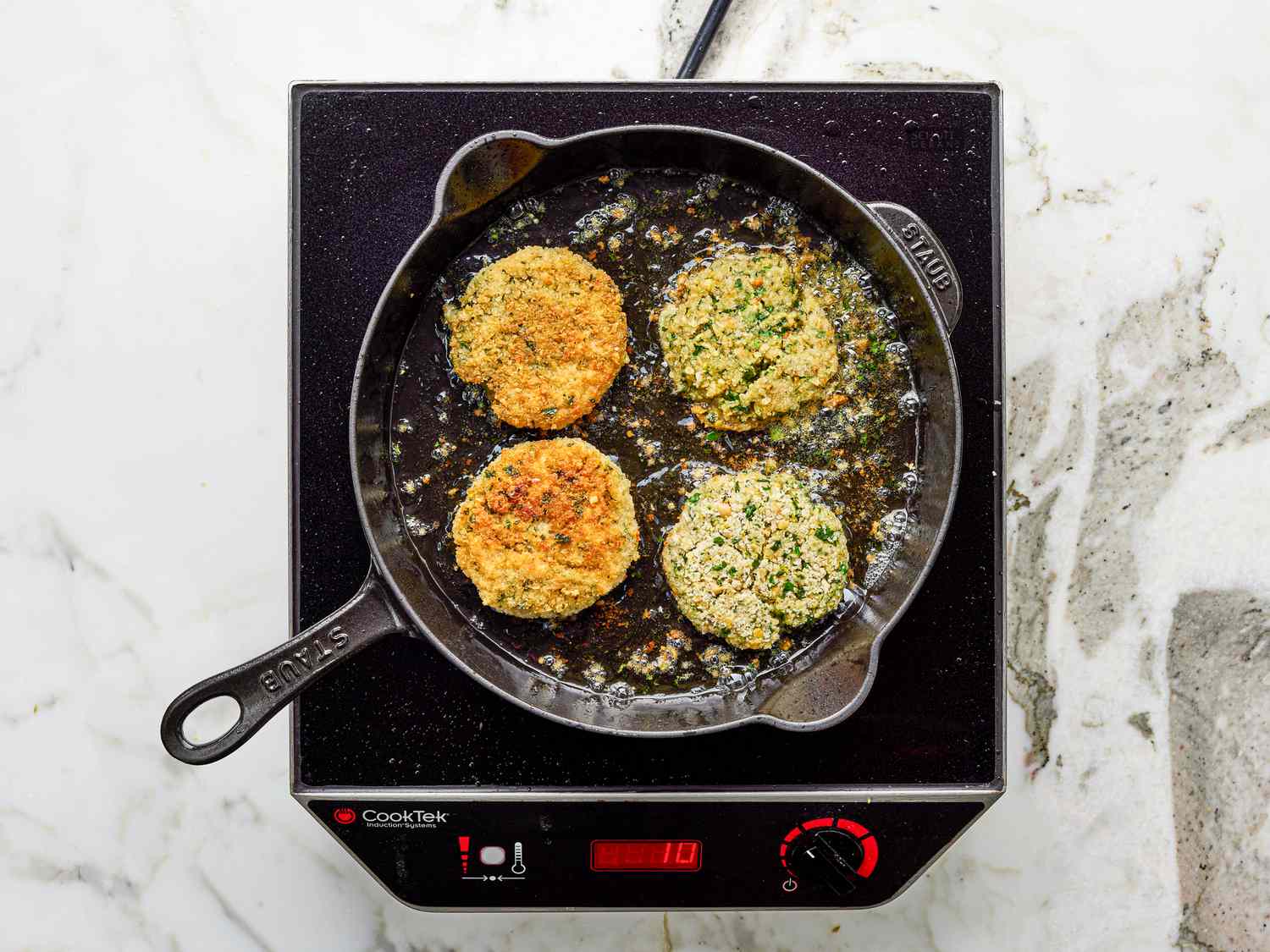 Overhead view of frying chickpea patties