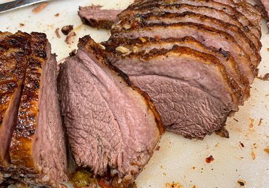Sliced cooked beef roast presented on a cutting board