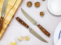 two messermeister knives on a white tile surface