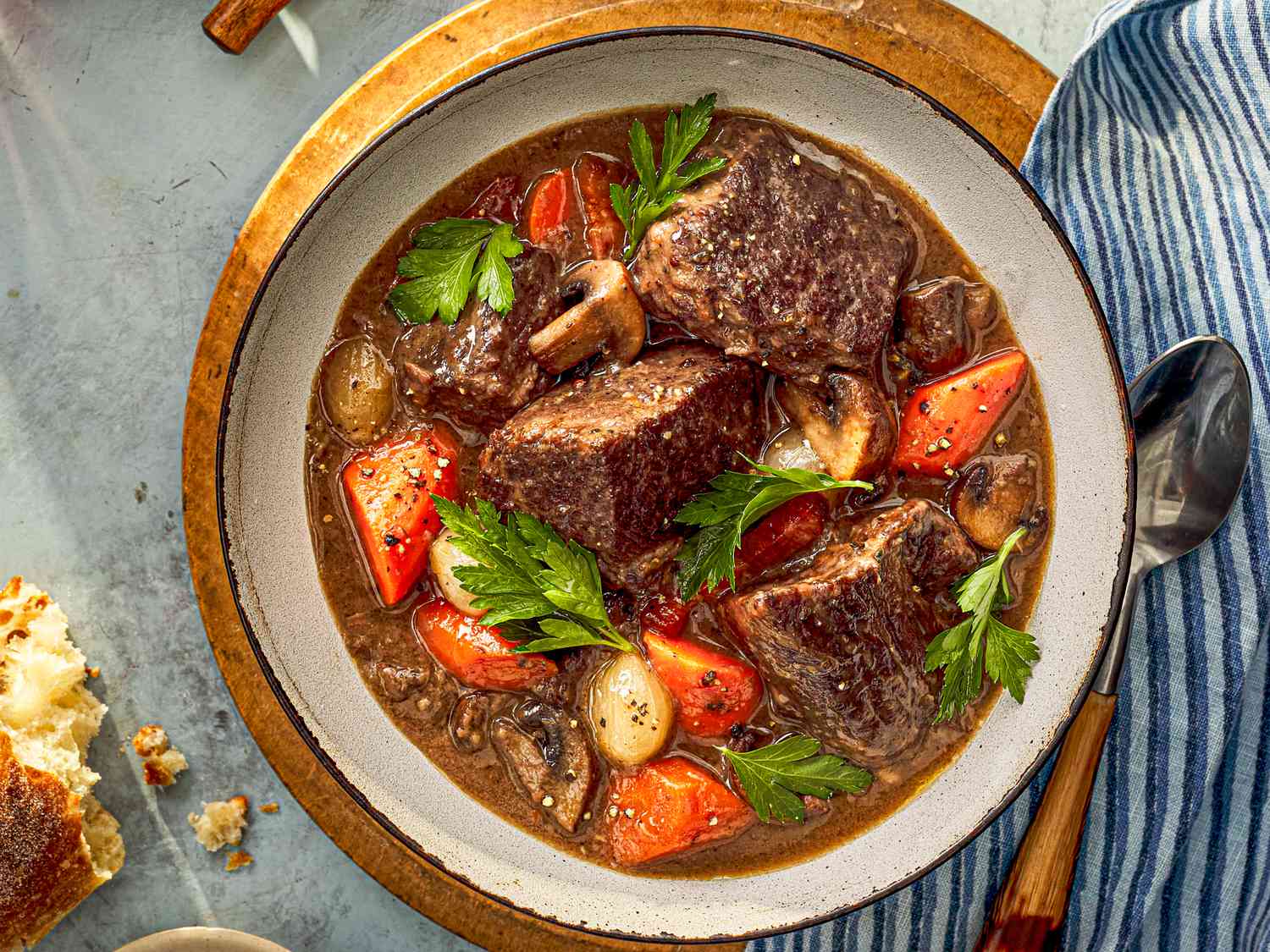 A bowl of beef bourguignon with big chunks of juicy beef, plump carrots, mushrooms and more.