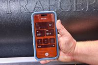 A person controls the Traeger Ironwood XL with their smartphone