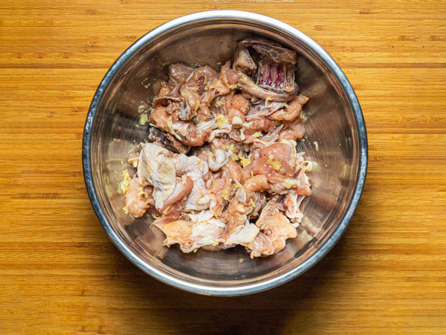 Overhead view of mixing chicken with lemongrass