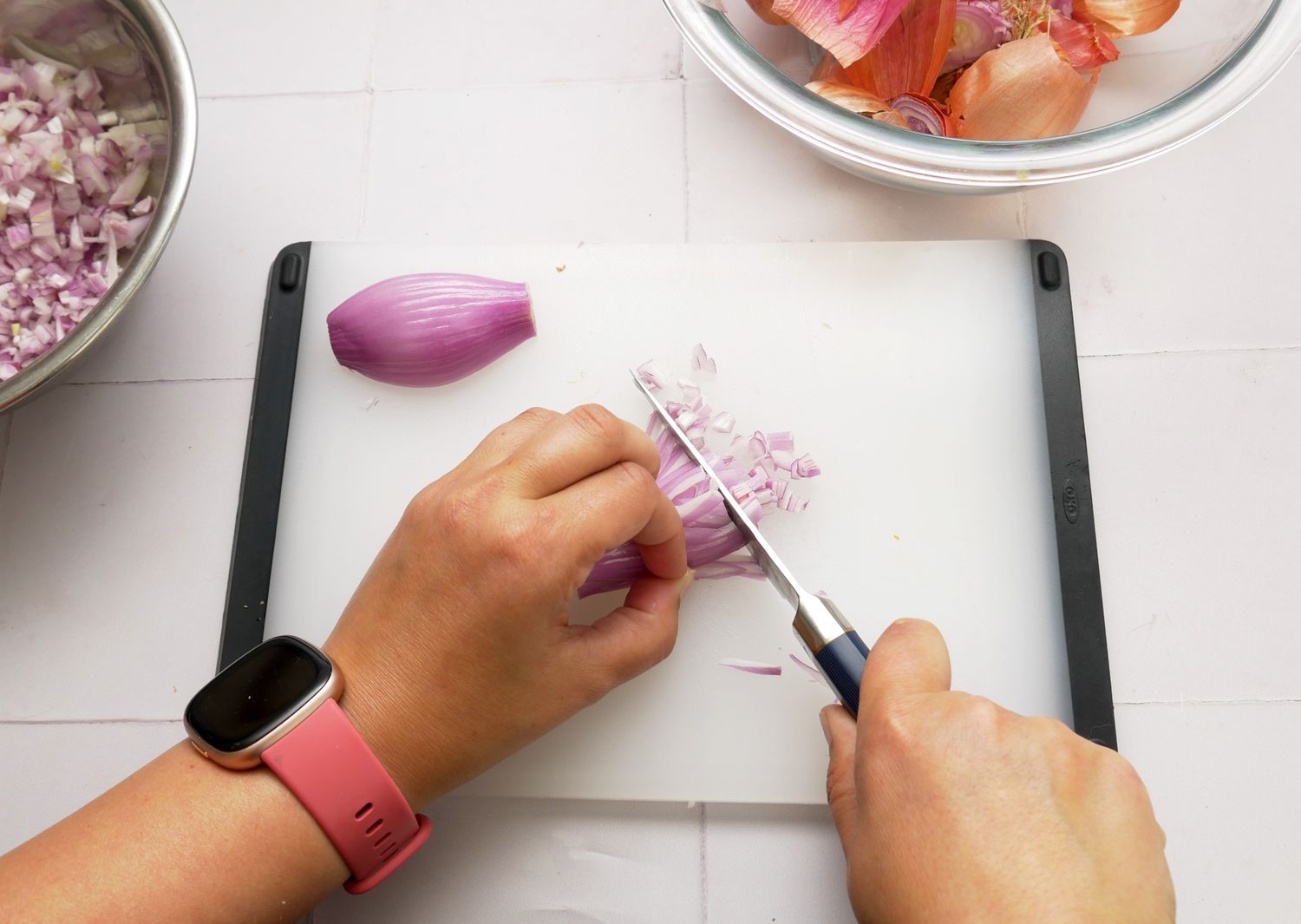 a person mincing shallots