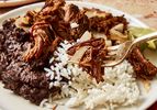 A plate of shredded beef with rice and black beans