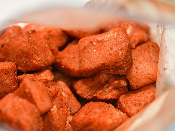 Closeup of the rub-coated pork cubes in a zip-top bag.