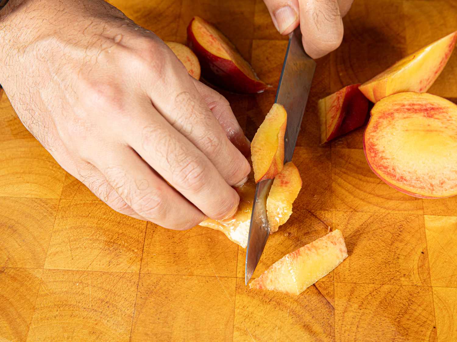 Overhead view of trimming peaches 