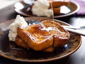 Orange-rum challah French toast, served with whipped crème fraîche and drizzled with maple syrup.