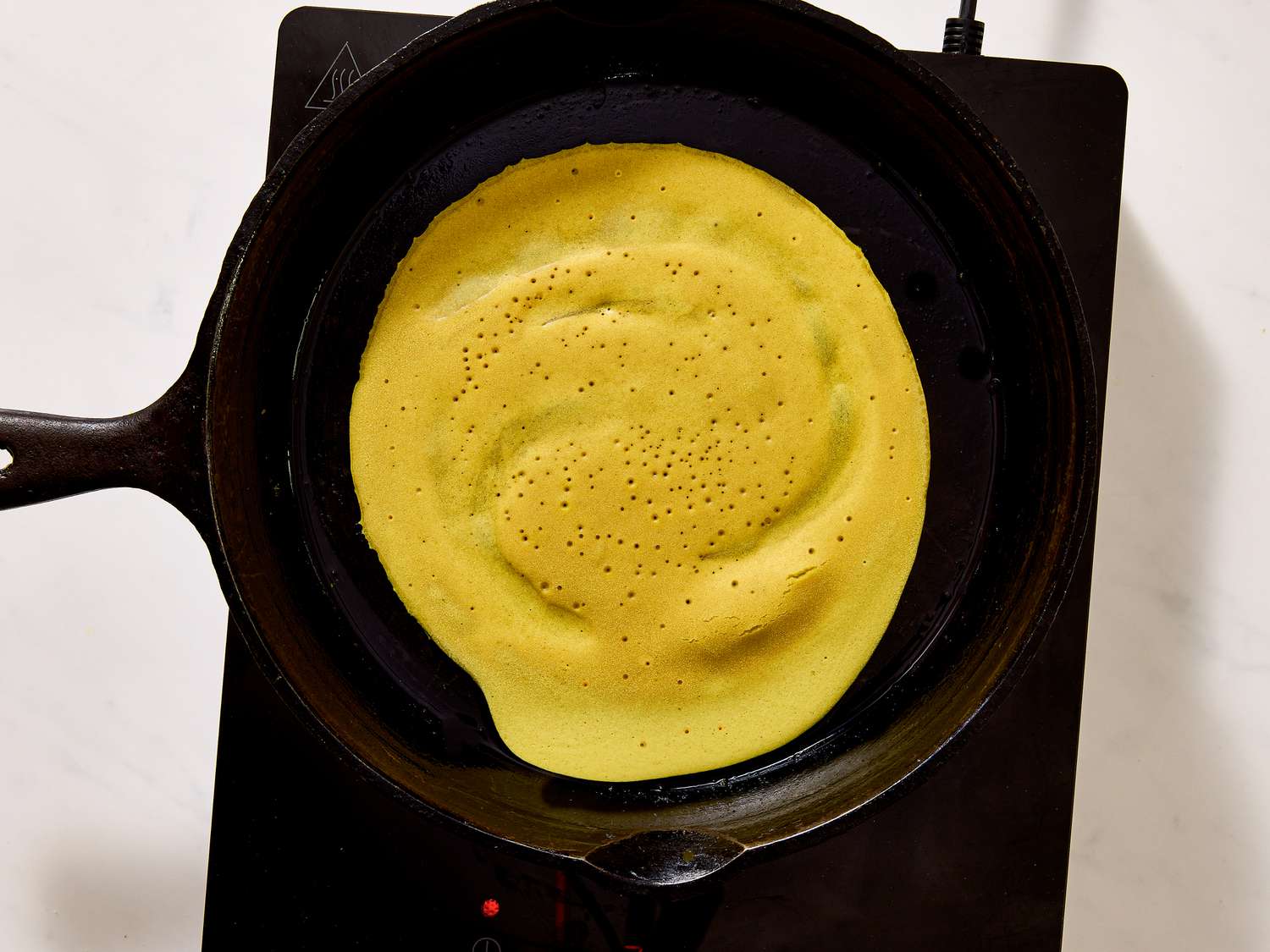 Ployes cooking on skillet 