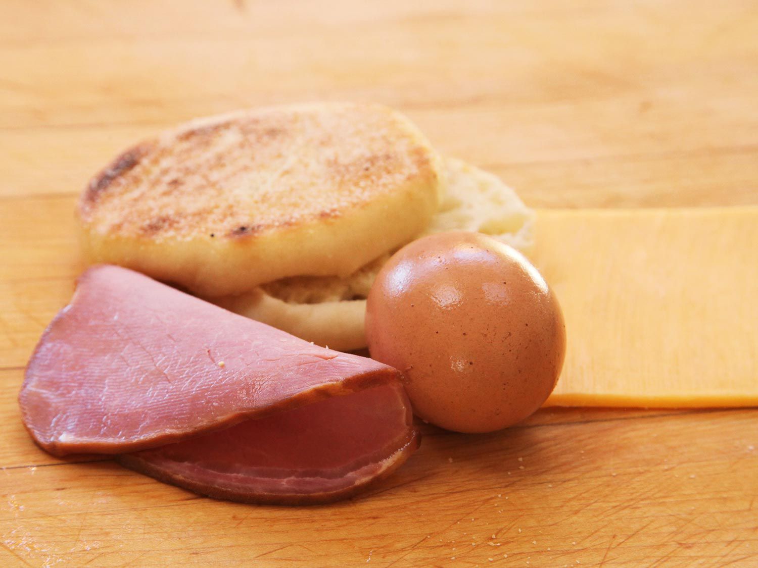 Copycat Egg McMuffin ingredients: an English muffin, Canadian bacon and an egg