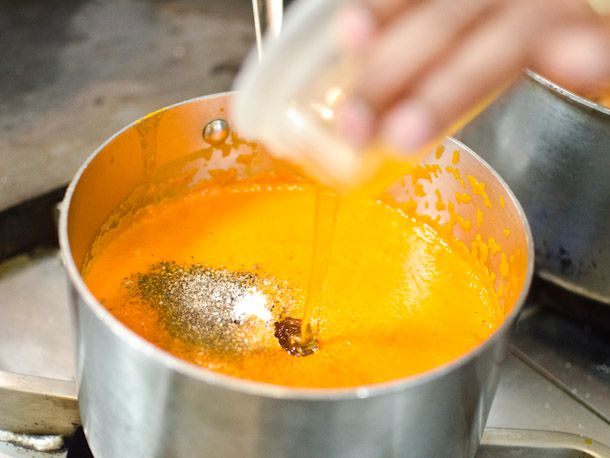 Adding honey, pepper, and salt to homemade butter chicken sauce