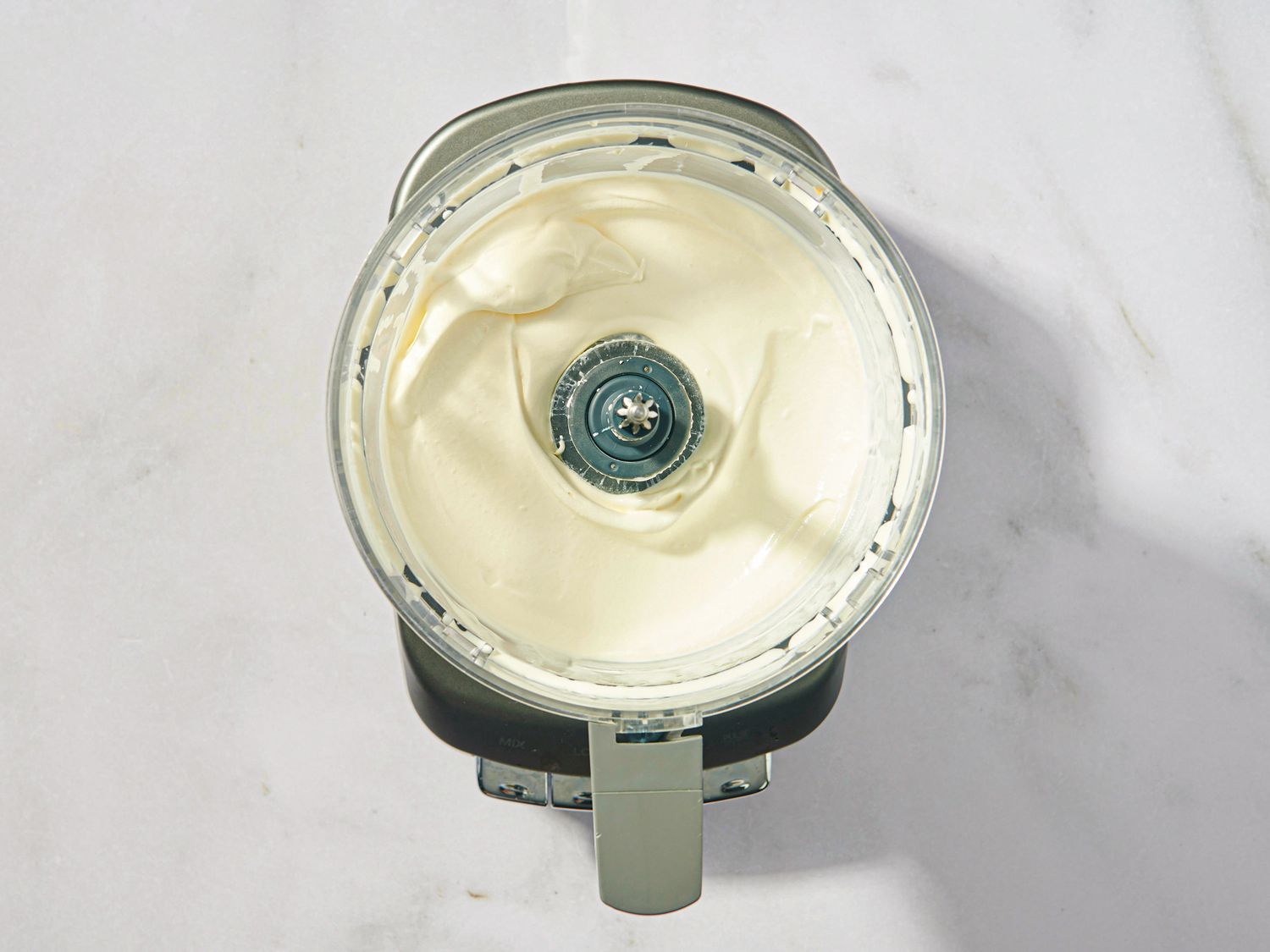 Blender with blended creamy mixture inside