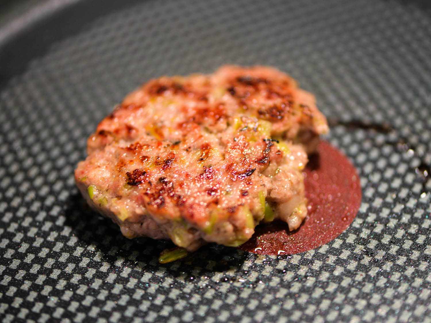 A test patty of the sausage is cooked in a nonstick skillet to check the seasoning.