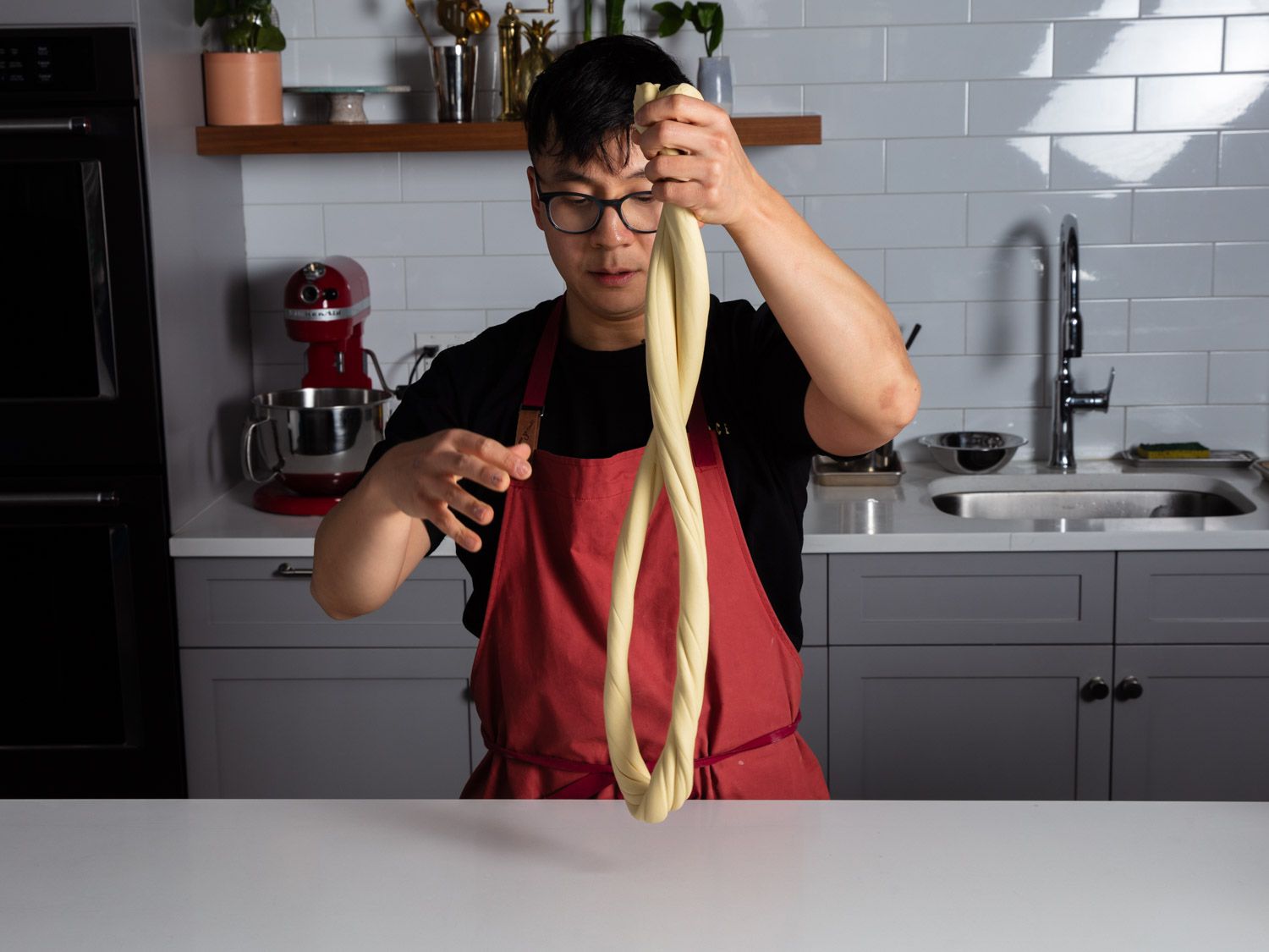 Tim twirling lamian noodle dough as it sags.
